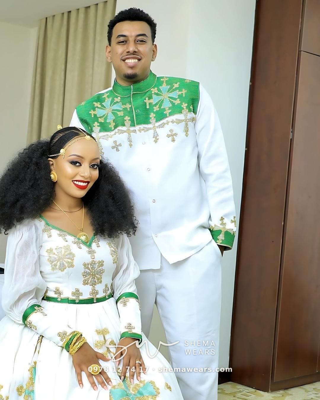 Groom in a white outfit with green and gold tibeb across the chest and shoulders