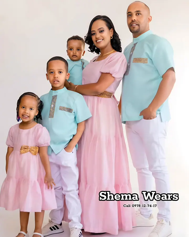 Family in matching pink and mint habesha outfits